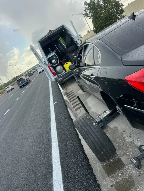 Mobile tire service van assisting a car on the roadside