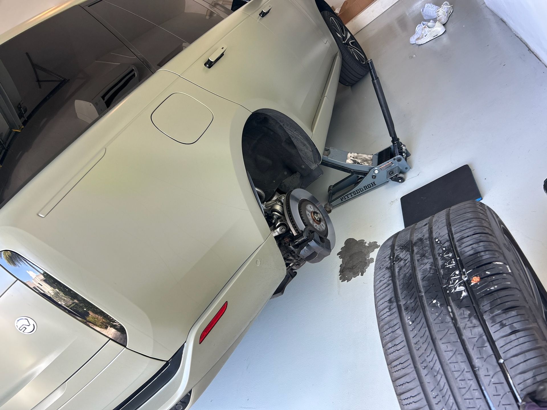 Tire replacement service with a vehicle lifted for repair in Lauderhill, Florida