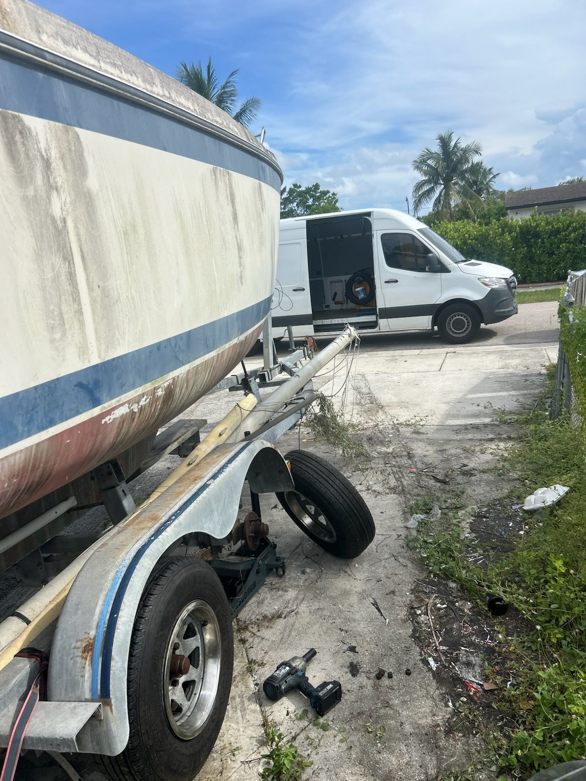 N & K technician replacing a trailer tire on-site in Pompano Beach, FL