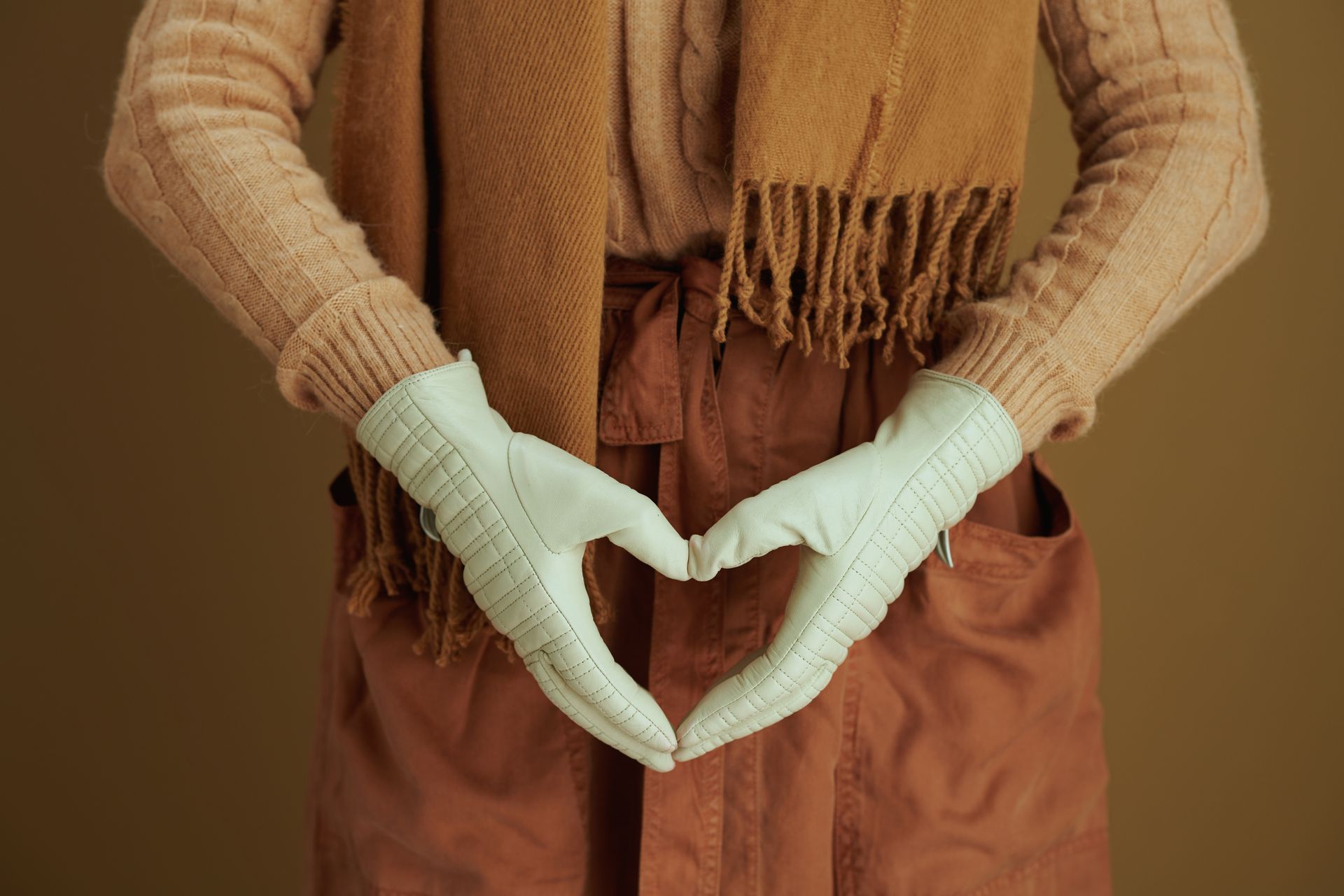 Woman flexing arm with dashed line marking upper arm on a white background