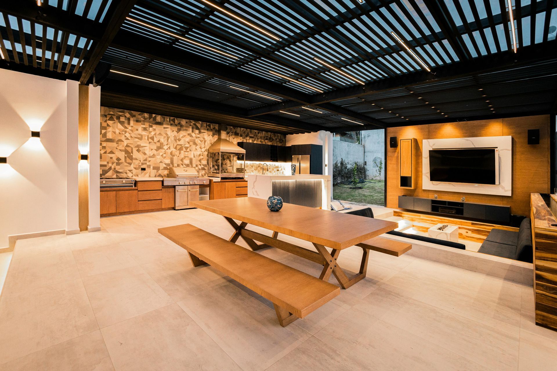 There is a picnic table and benches in the middle of the room.