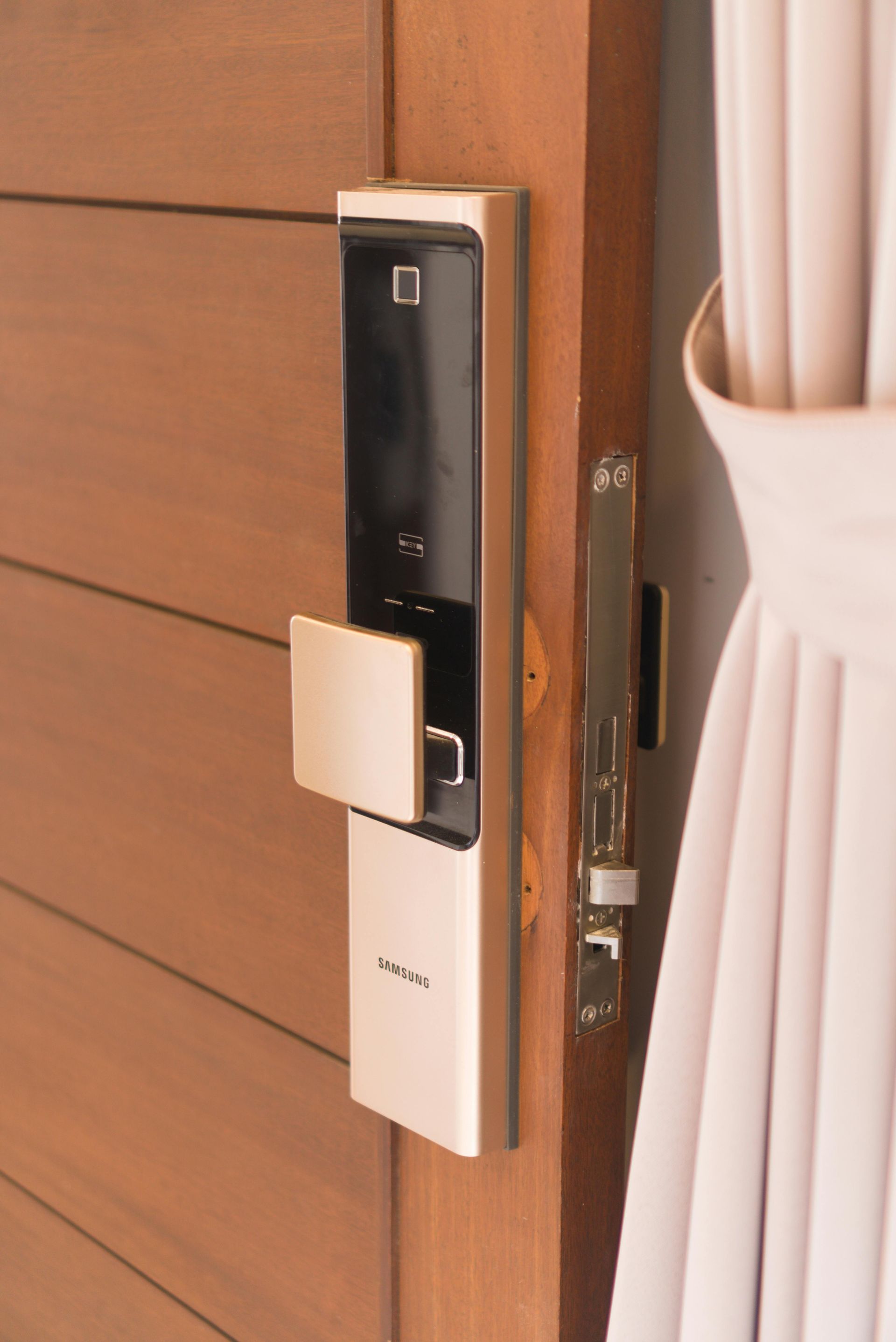 A close up of a door lock on a wooden door