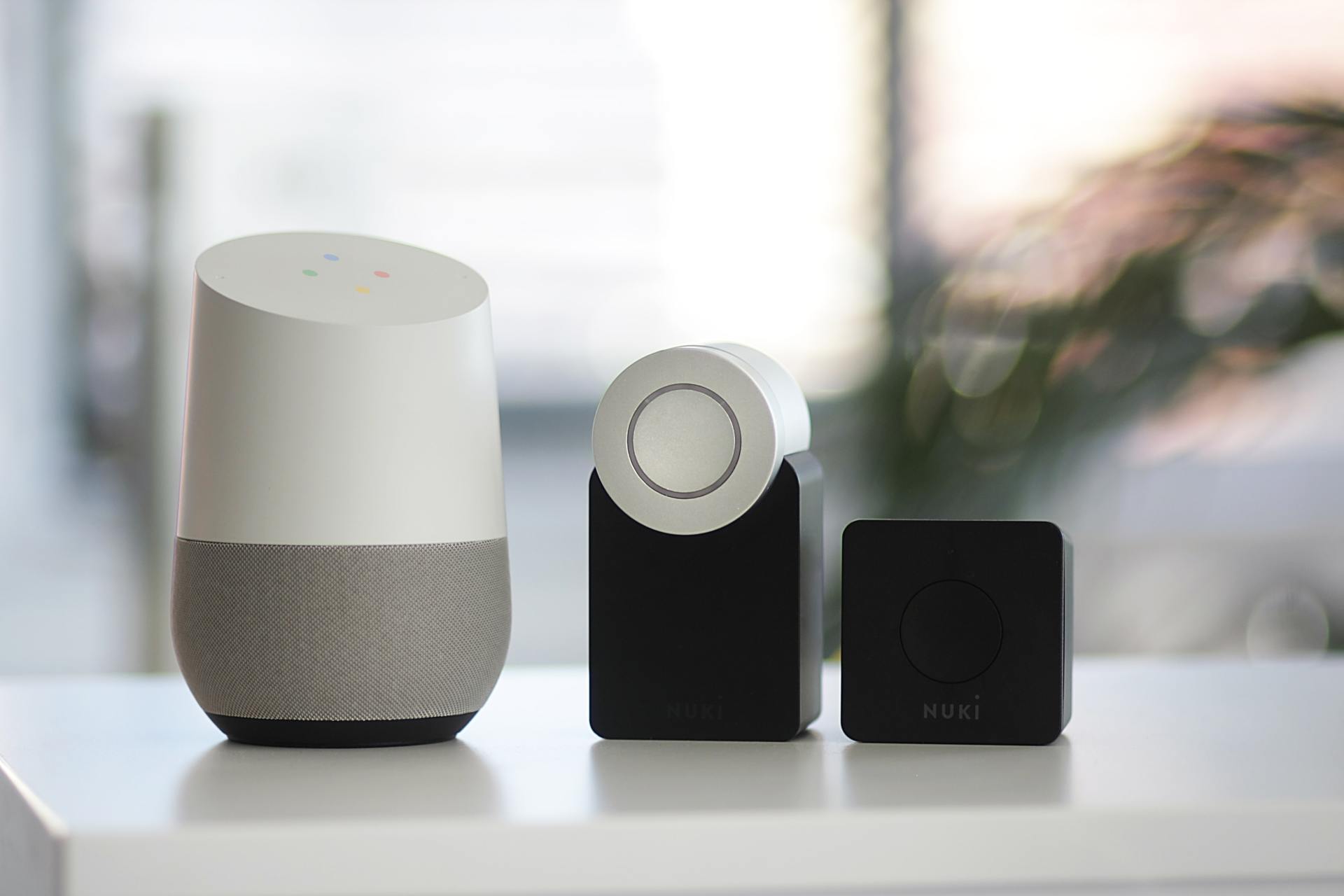 Three smart speakers are sitting on top of a white table.