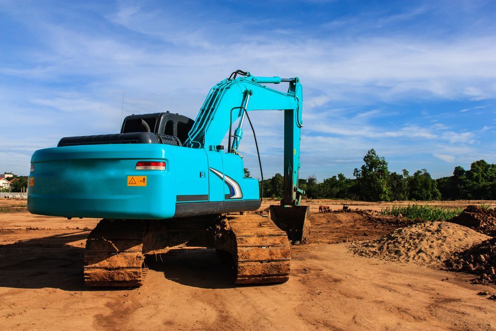 Turquoise Excavator on a Dirt Construction Site — Border Rockwalls in Gold Coast, NSW