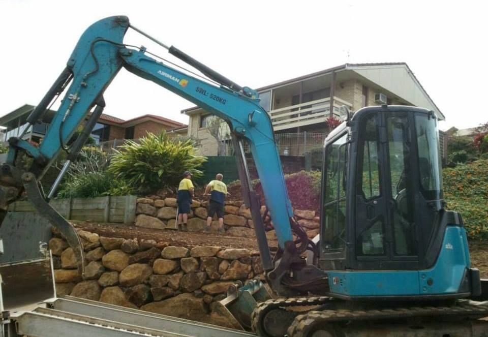 Blue Excavator Working On A Retaining Wall — Border Rockwalls in Stotts Creek, NSW