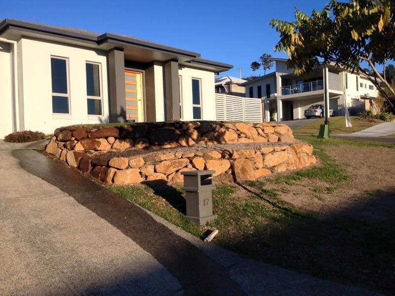 Modern House With Stone Retaining Wall and Sloped Driveway —Border Rockwalls in Stotts Creek, NSW