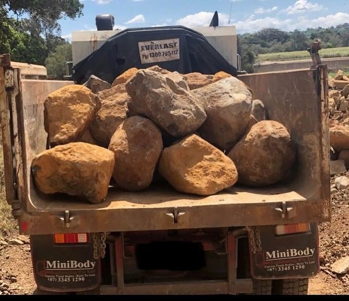 Dump Truck Bed Filled With Large Tan Rocks on a Rural Dirt Road — Border Rockwalls in Stotts Creek, NSW