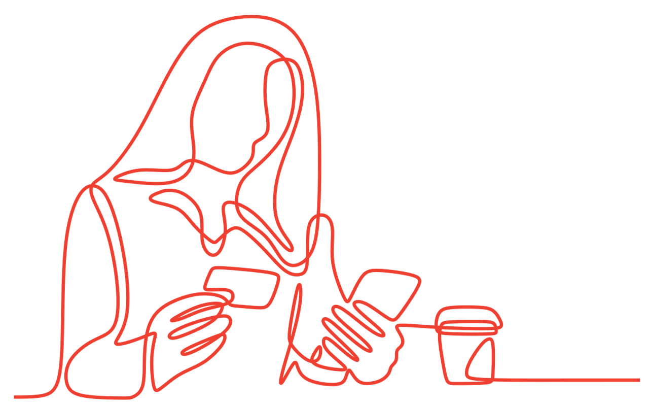Woman with long hair using phone, holding credit card, sitting with coffee cup.