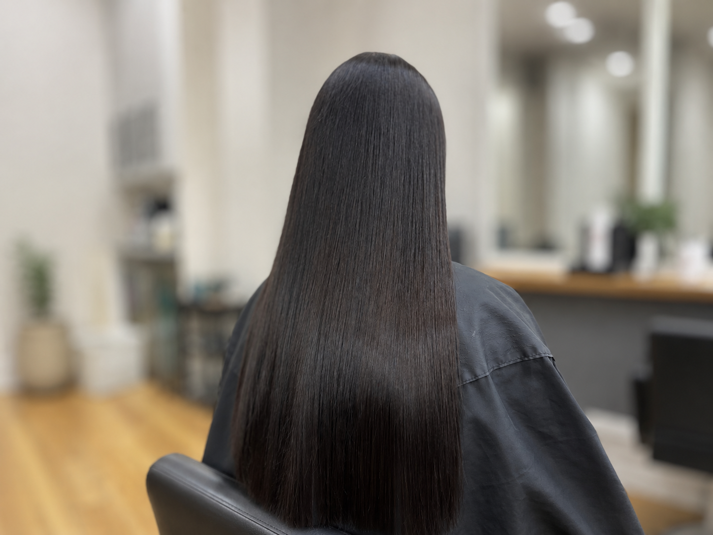 Person with Long Reddish-Brown Hair Sitting Indoors — Hair to Impress In Lisarow, NSW