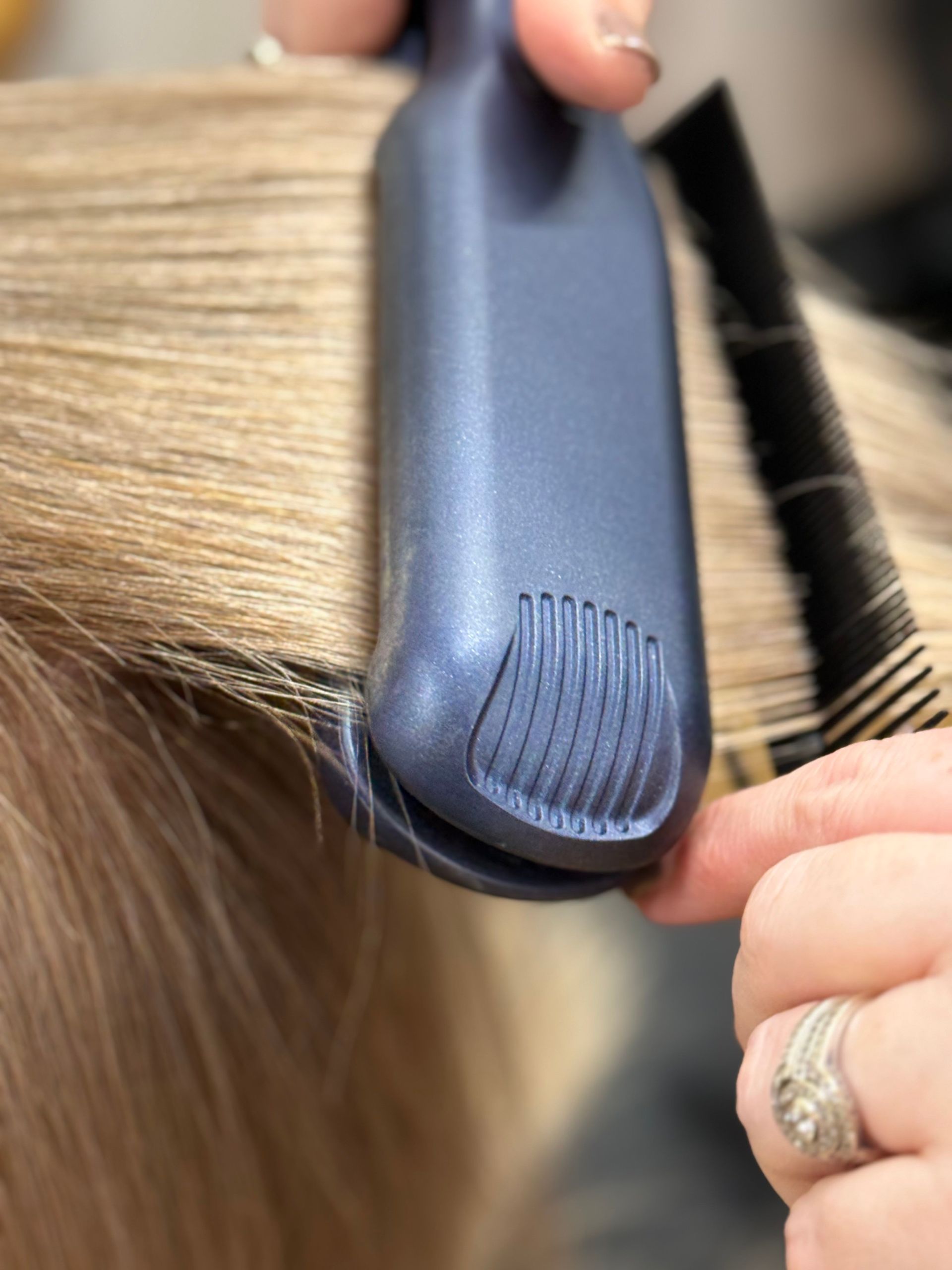 Hair stylist using comb and scissors to trim short gray hair in a salon - Hair to Impress in Lisarow NSW