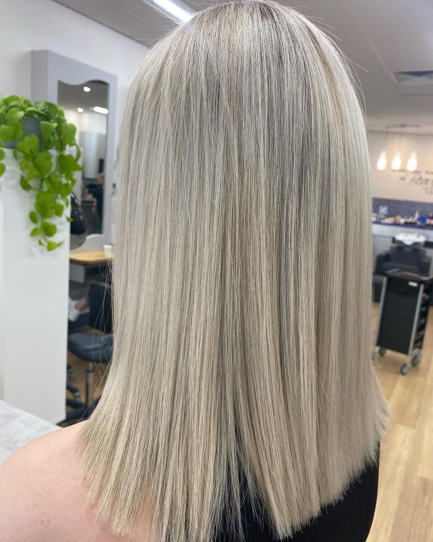 Blonde shoulder-length haircut with textured ends in a salon interior — Hair to Impress In Lisarow, NSW