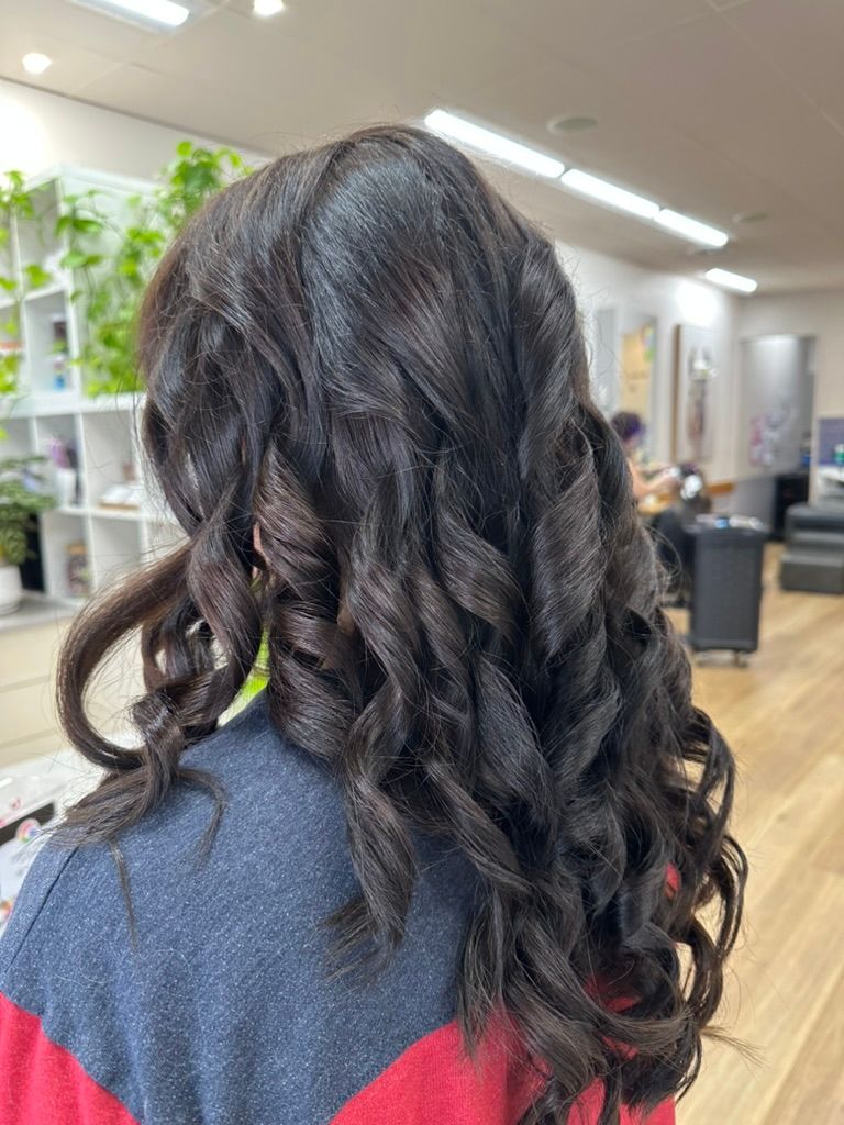 Long Dark Curly Hair Seen from Behind in A Salon Chair — Hair to Impress In Lisarow, NSW