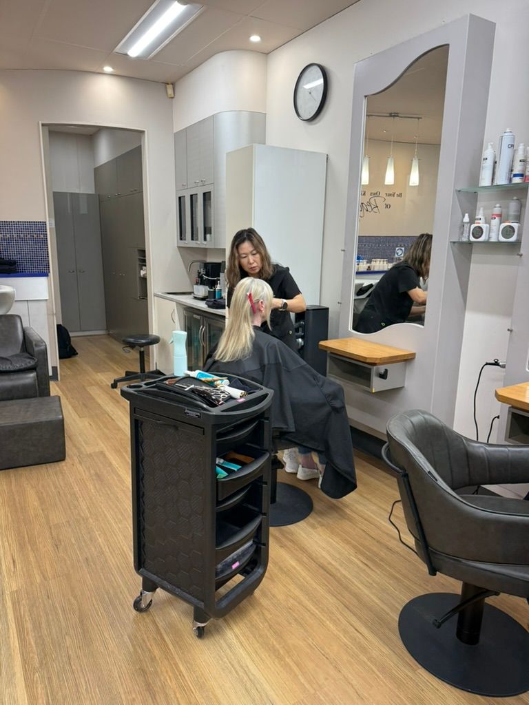 Hair Salon Interior with Stylist at A Station — Hair to Impress In Lisarow, NSW