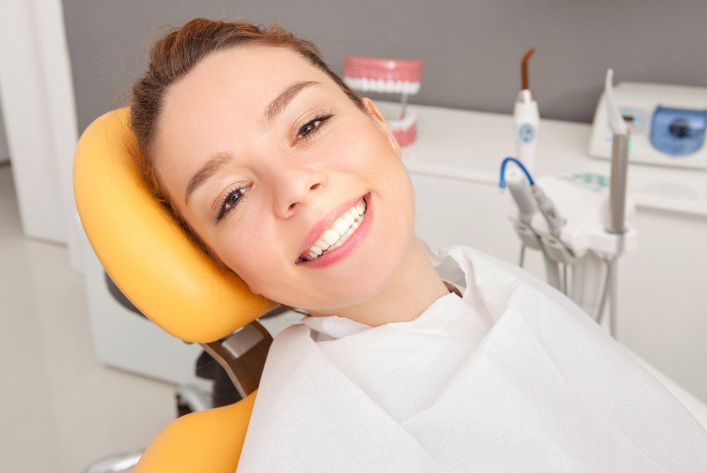 Smiling Woman Inside Dental Clinic — Lenoir, NC — Wayne Hollar DDS Smiling Woman Inside Dental Clinic — Lenoir, NC — Wayne Hollar DDS