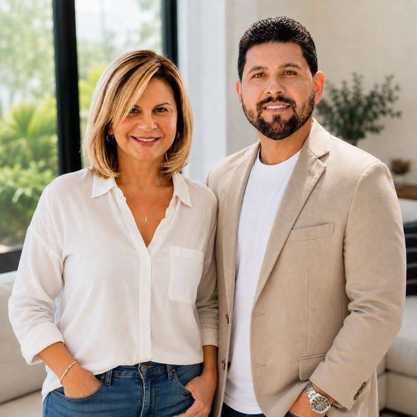 Ivette Rivero and Jordan Aguila, mother-and-son real estate team, standing together outside a South Florida home.