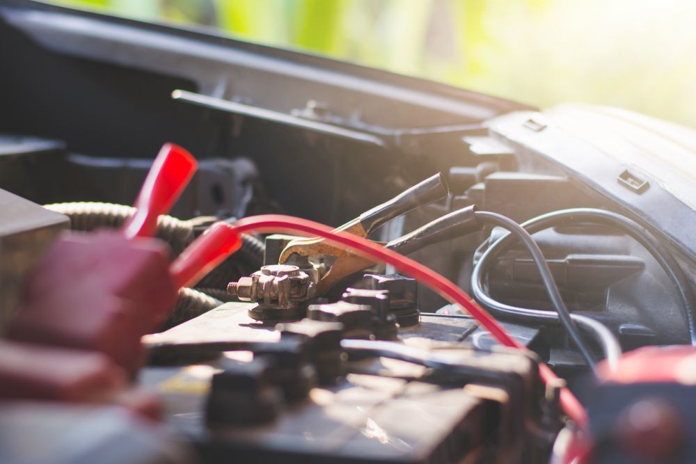 A Car Battery is Being Charged With a Jump Starter — Norm Beatty's Auto Electrical Service In The Entrance, NSW