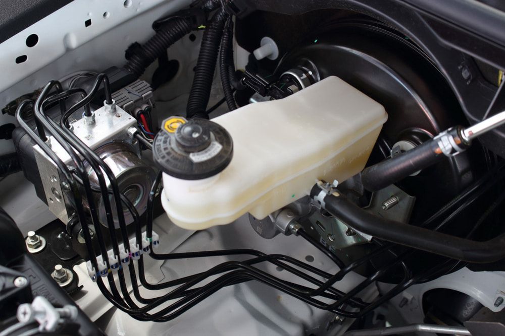 A Car's Engine Compartment Showing a Brake Master Cylinder — Norm Beatty's Auto Electrical Service In Long Jetty, NSW