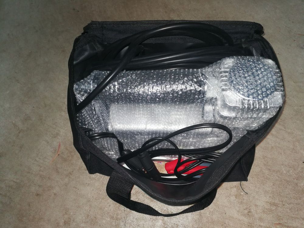A Portable Air Compressor Sits Inside a Black Bag — Norm Beatty's Auto Electrical Service In Long Jetty, NSW