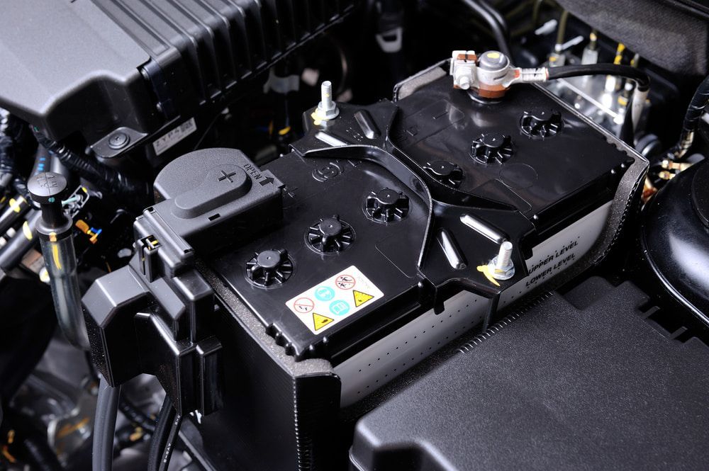 A Car Battery in an Engine Bay — Norm Beatty's Auto Electrical Service In Long Jetty, NSW