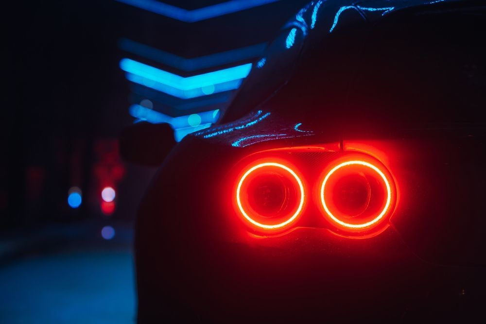 A Car's Rear With Glowing Red Taillights — Norm Beatty's Auto Electrical Service In Long Jetty, NSW