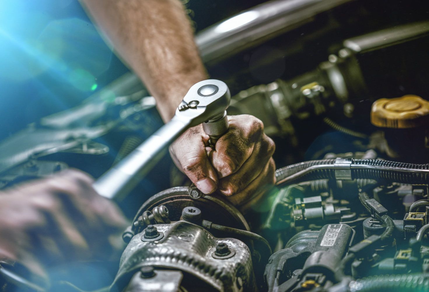 Person Uses a Wrench to Work on a Car Engine — Norm Beatty's Auto Electrical Service In Long Jetty, NSW