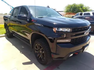 Black Chevrolet pickup truck parked outdoors in bright sunlight