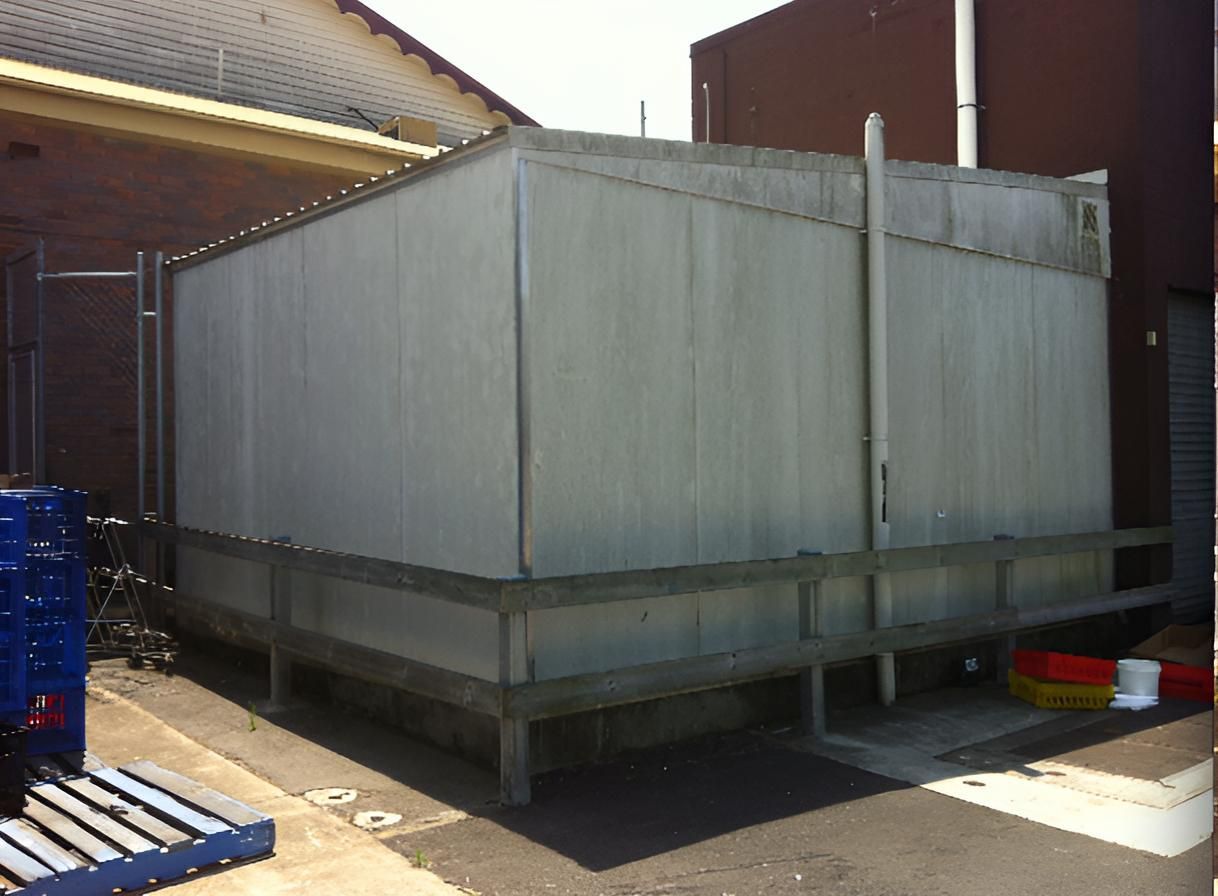 A Large Gray Container Is Sitting Outside Of A Building — EcoPro Pressure Cleaning In Broadbeach Waters, QLD