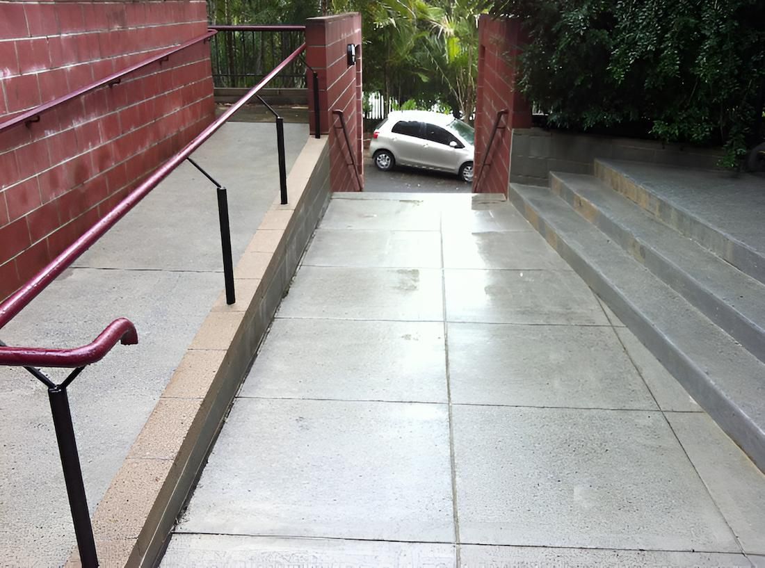 A White Car Is Parked On The Side Of A Ramp — EcoPro Pressure Cleaning In Brisbane, QLD