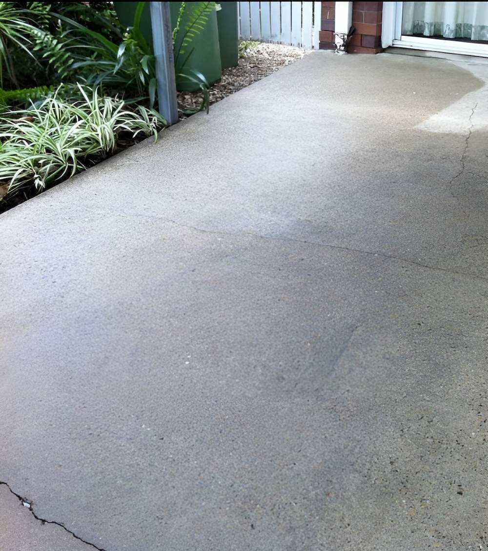 A Concrete Walkway Leading To A House With A Fence In The Background — EcoPro Pressure Cleaning In Coolangatta, QLD
