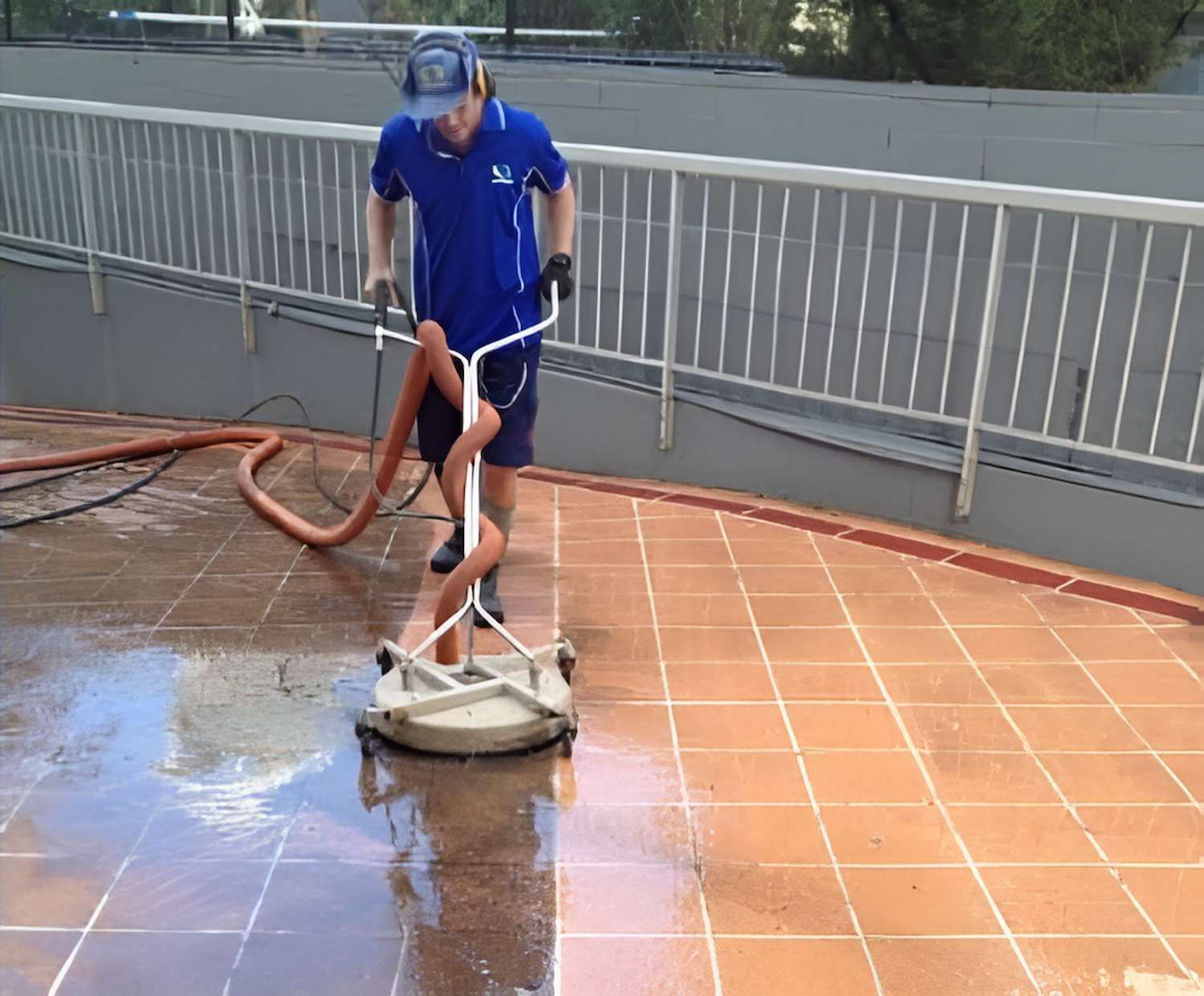 A Man Is Cleaning A Tiled Floor With A Vacuum Cleaner — EcoPro Pressure Cleaning In Broadbeach Waters, QLD