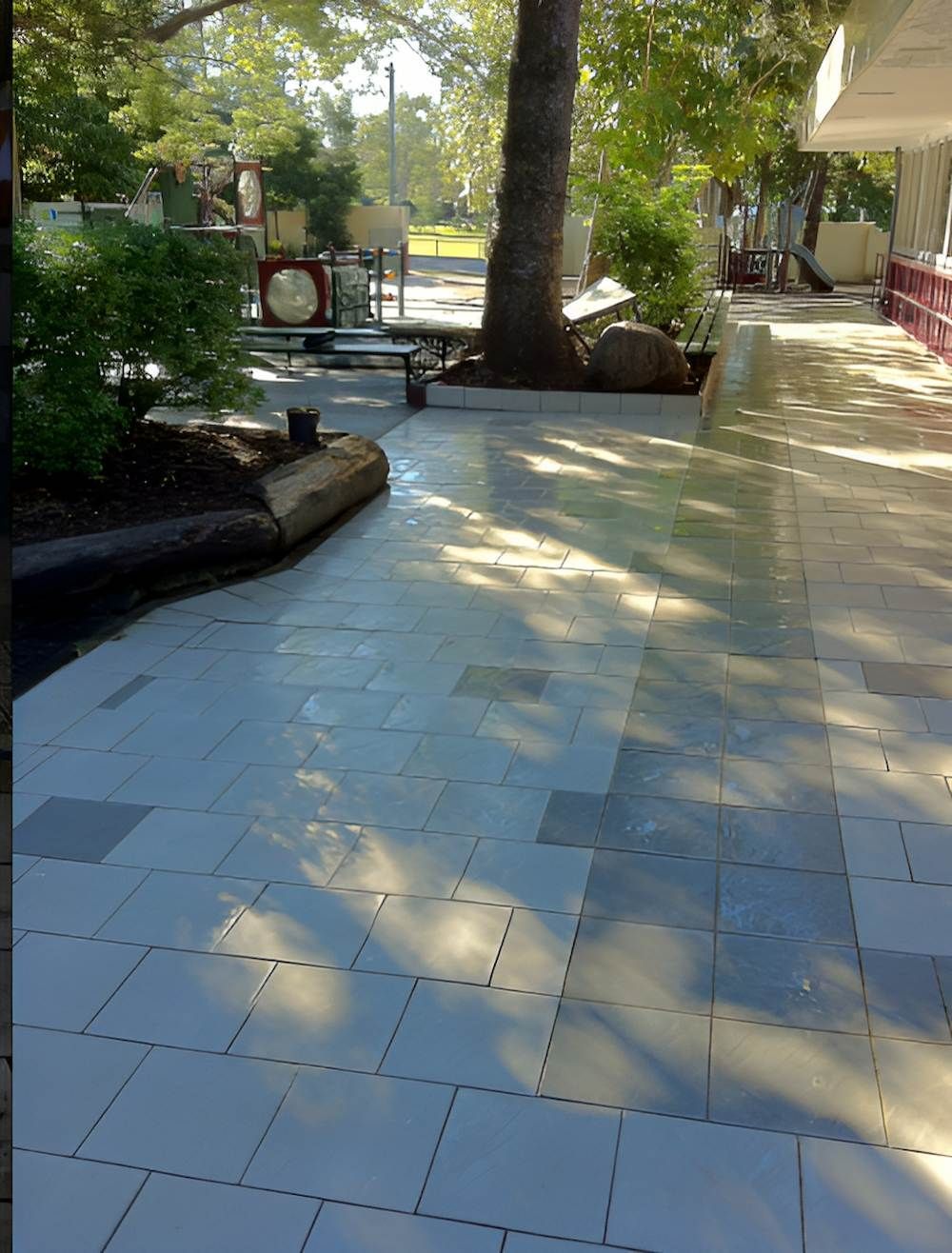 A Brick Walkway With Trees In The Background — EcoPro Pressure Cleaning In Robina, QLD