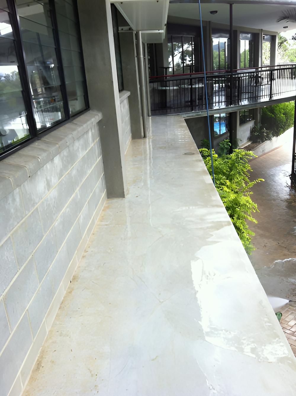 A Long Hallway With A Balcony On The Side Of A Building — EcoPro Pressure Cleaning In Brisbane, QLD