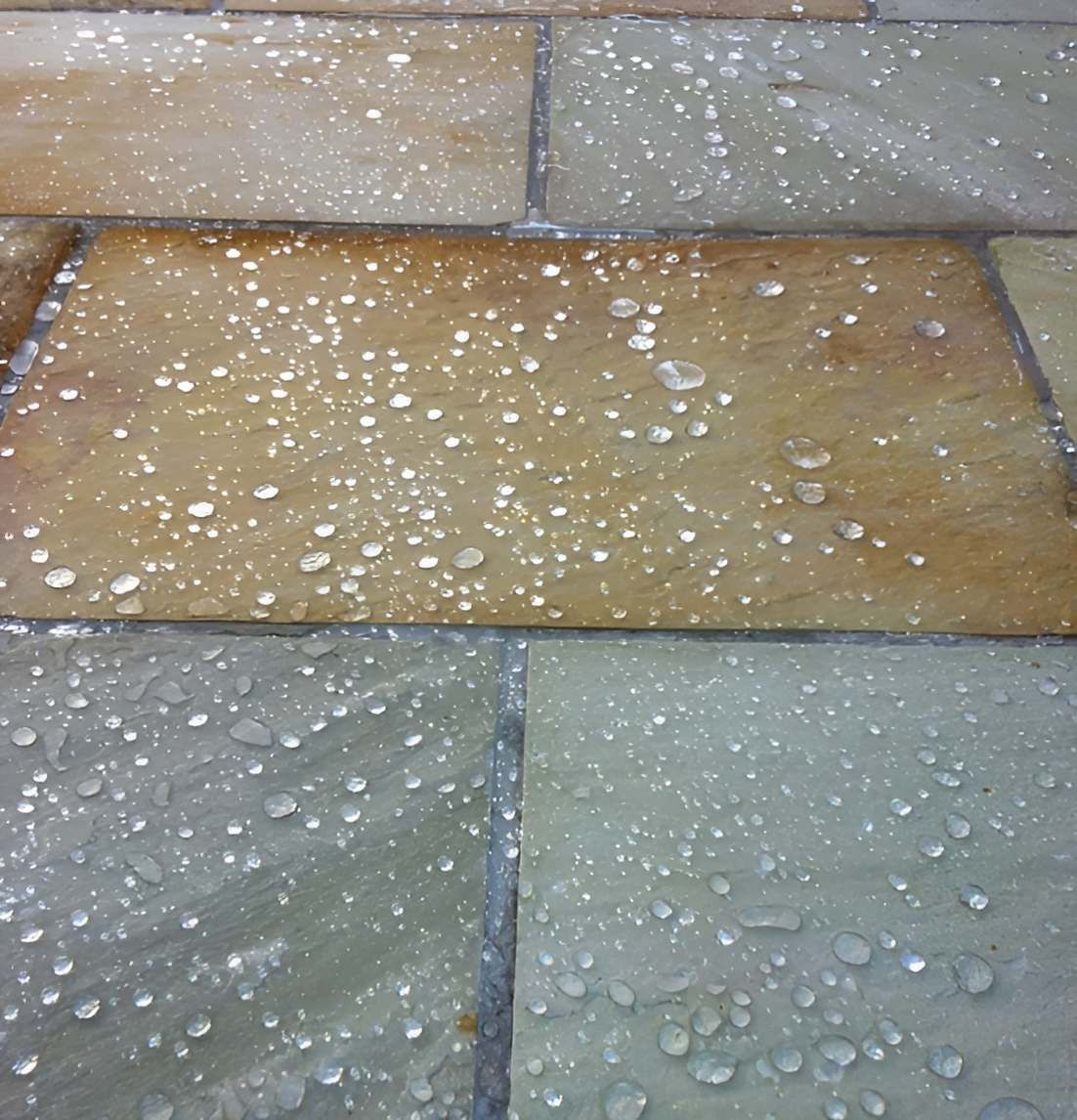 A Close Up Of A Tile Floor With Water Drops On It — EcoPro Pressure Cleaning In Broadbeach Waters, QLD