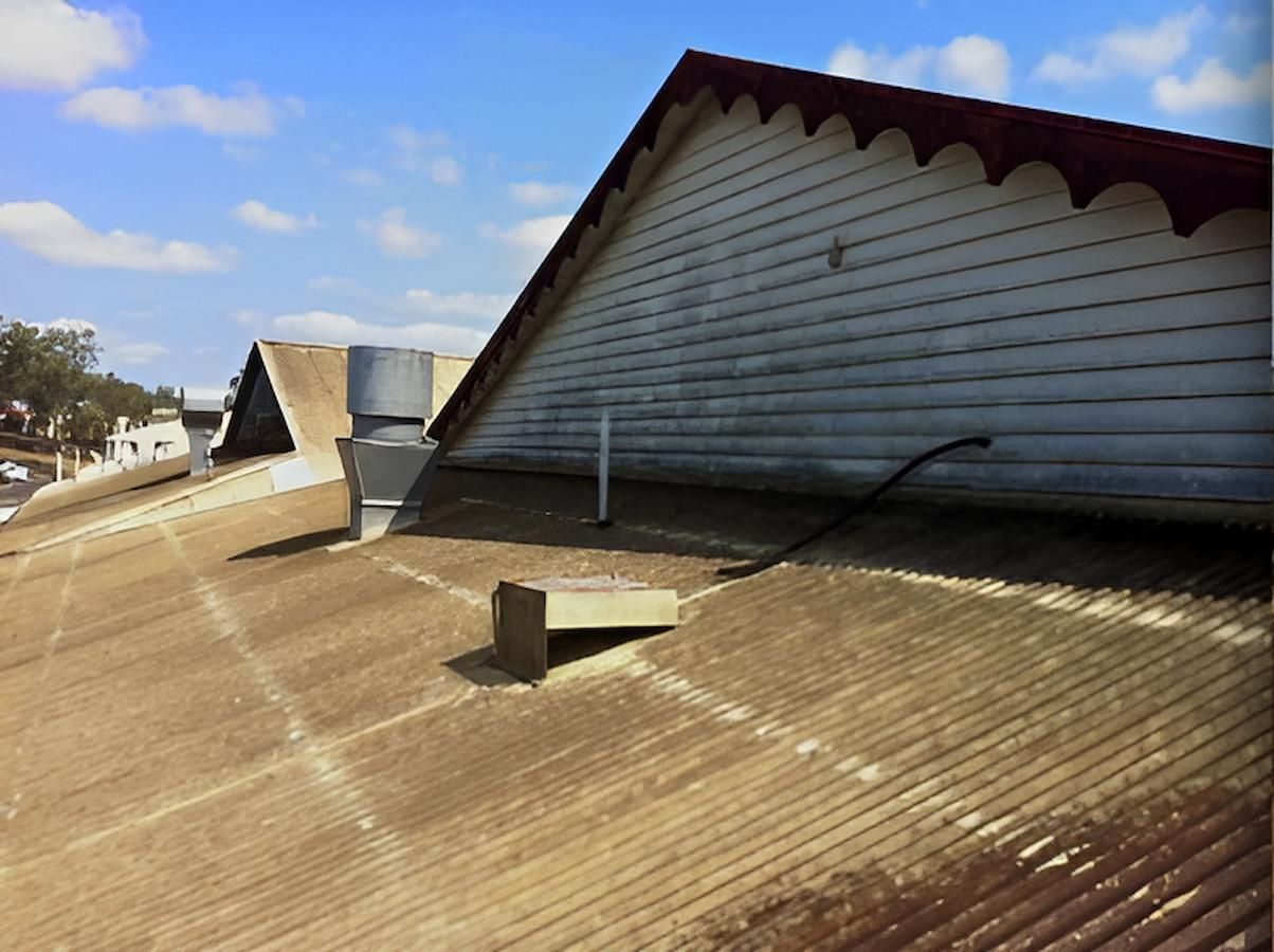 The Roof Of A Building Has A Hole In It — EcoPro Pressure Cleaning In Robina, QLD