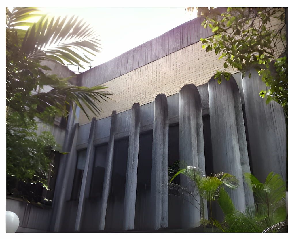 A Large Building With A Lot Of Windows Is Surrounded By Trees — EcoPro Pressure Cleaning In Broadbeach Waters, QLD