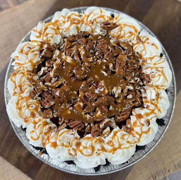 Chocolate and caramel topped whipped cream dessert on a plate