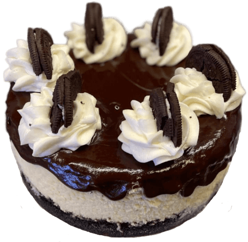 Chocolate cake topped with whipped cream swirls and Oreo cookies on a white background