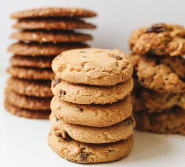 Stacks of chocolate chip cookies on a white background