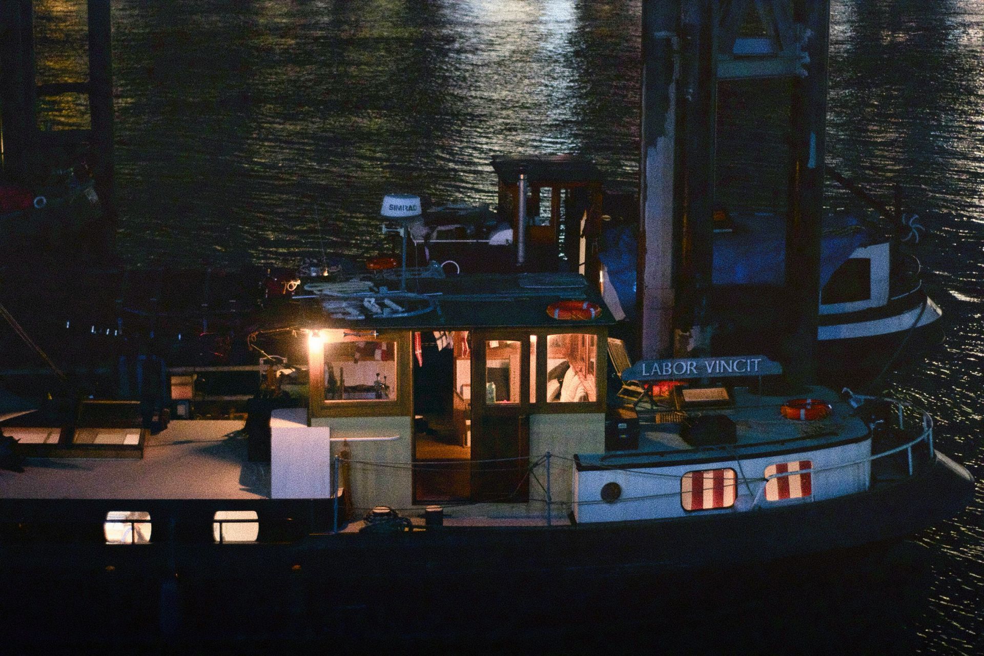 Commercial tugboat illuminated by marine lighting during nighttime operations