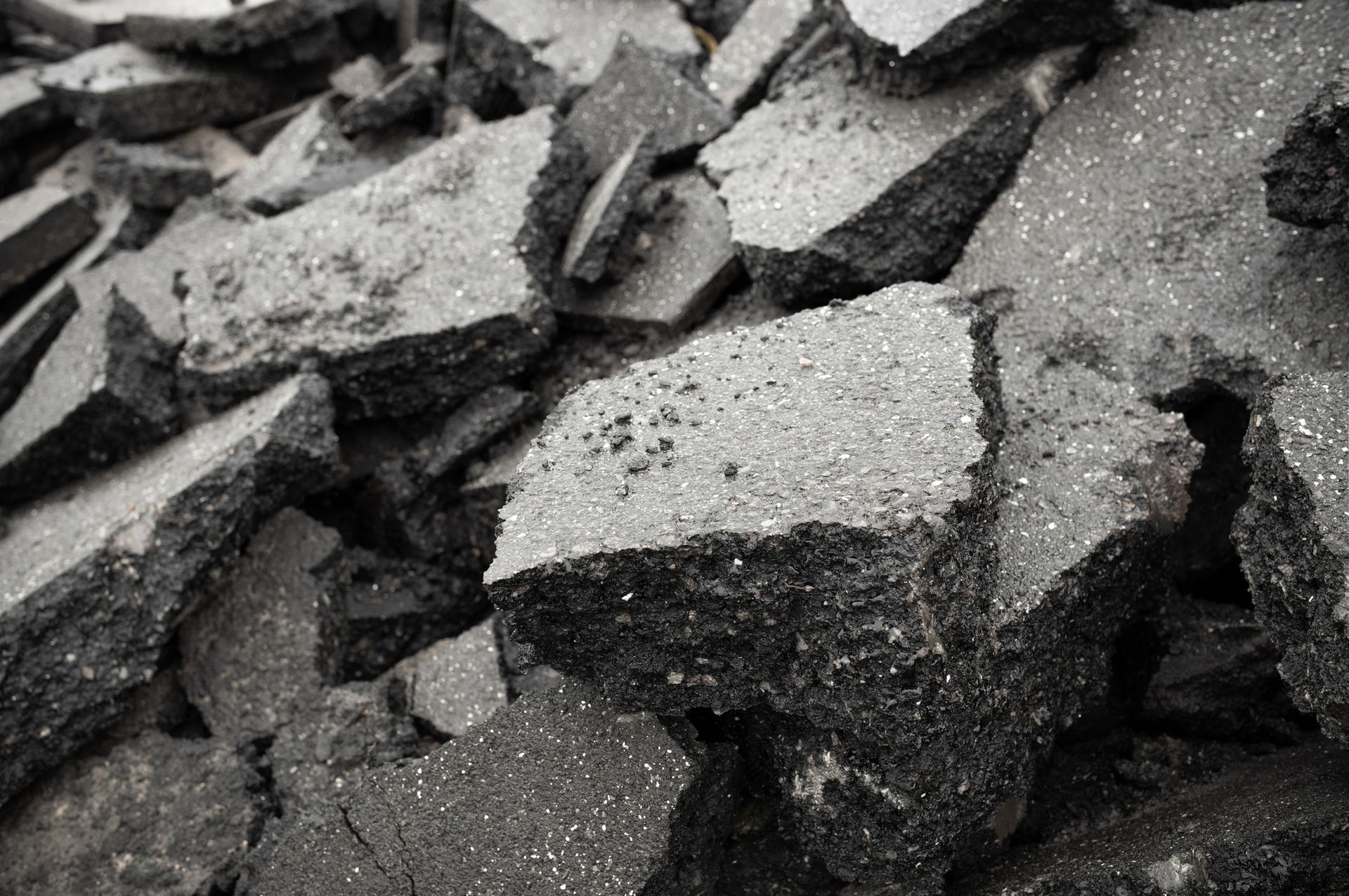 A black and white photo of a pile of broken asphalt.
