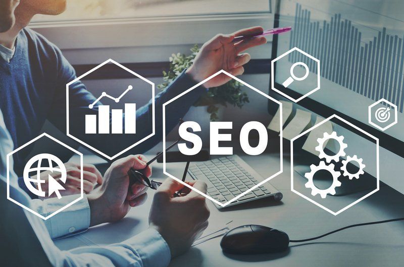 SEO graphic overlaying a person pointing at a computer screen