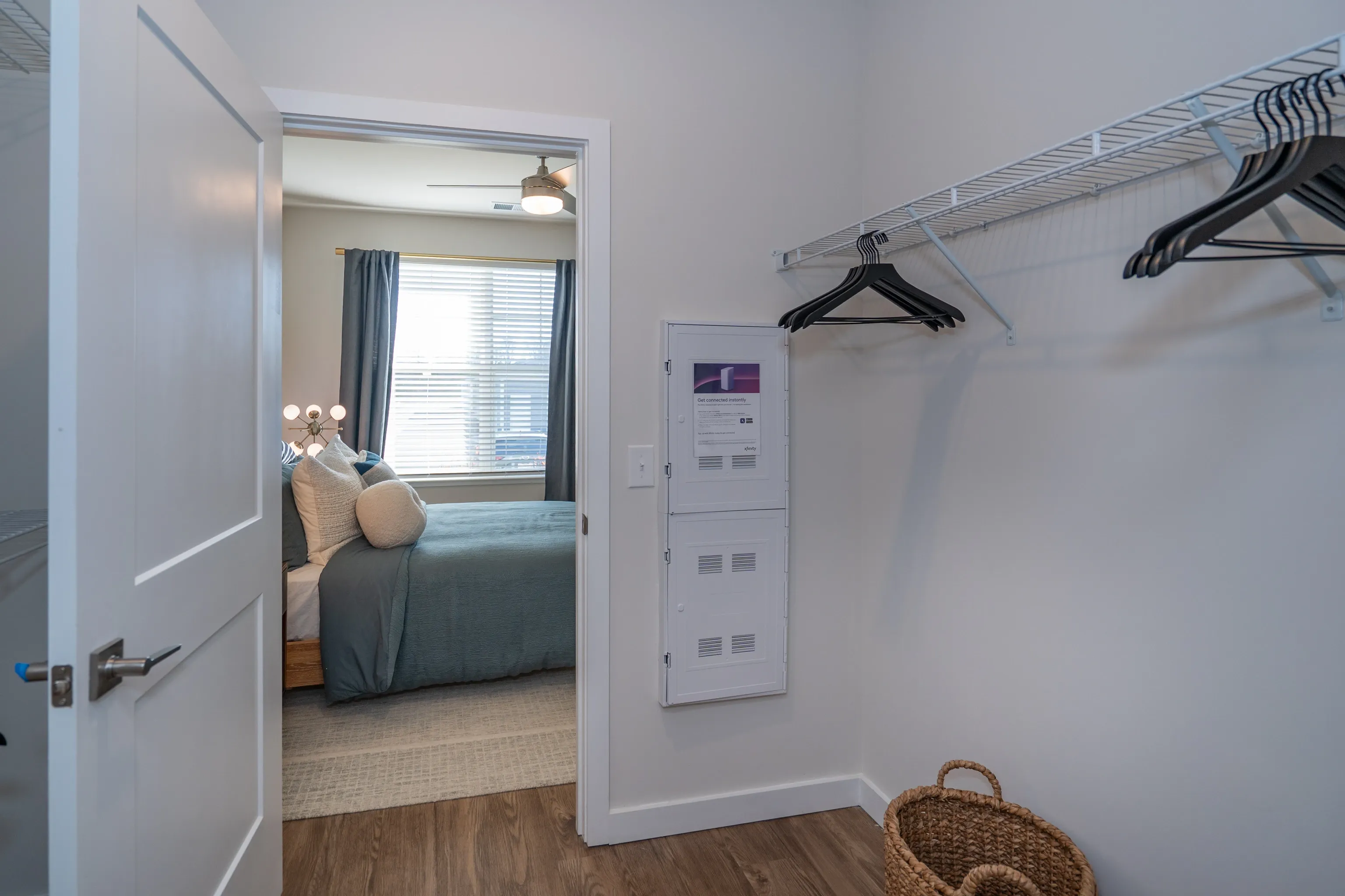 Bedroom and closet with hanging clothes and storage