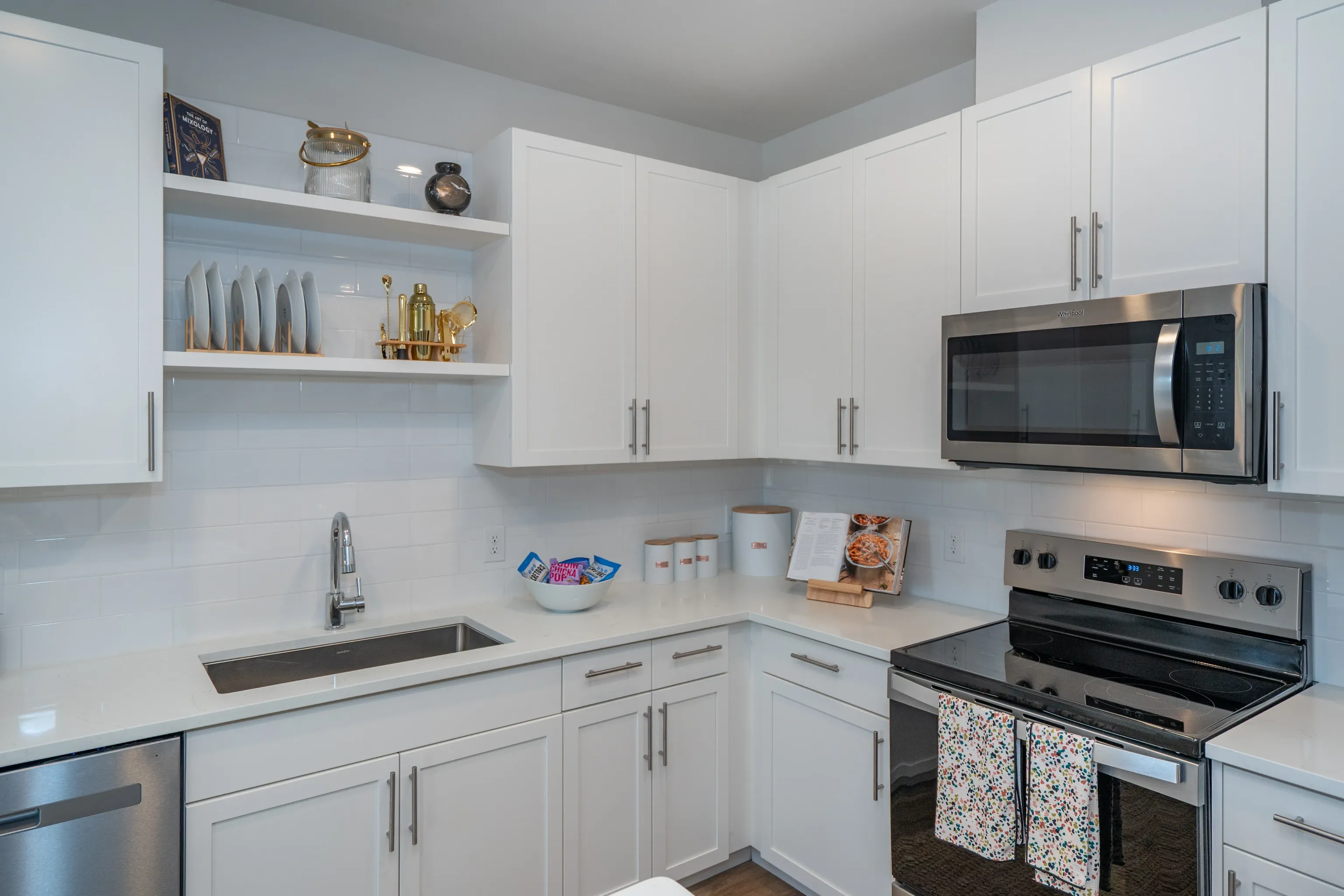 Modern kitchen with white cabinets, stainless steel appliances, and subway tile backsplash.