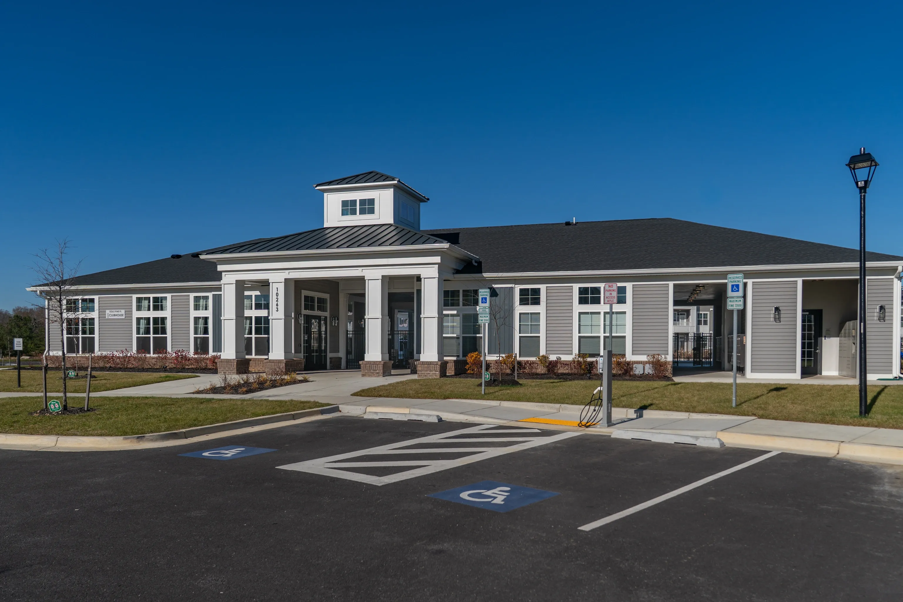 Building exterior with accessible parking spaces in the foreground.