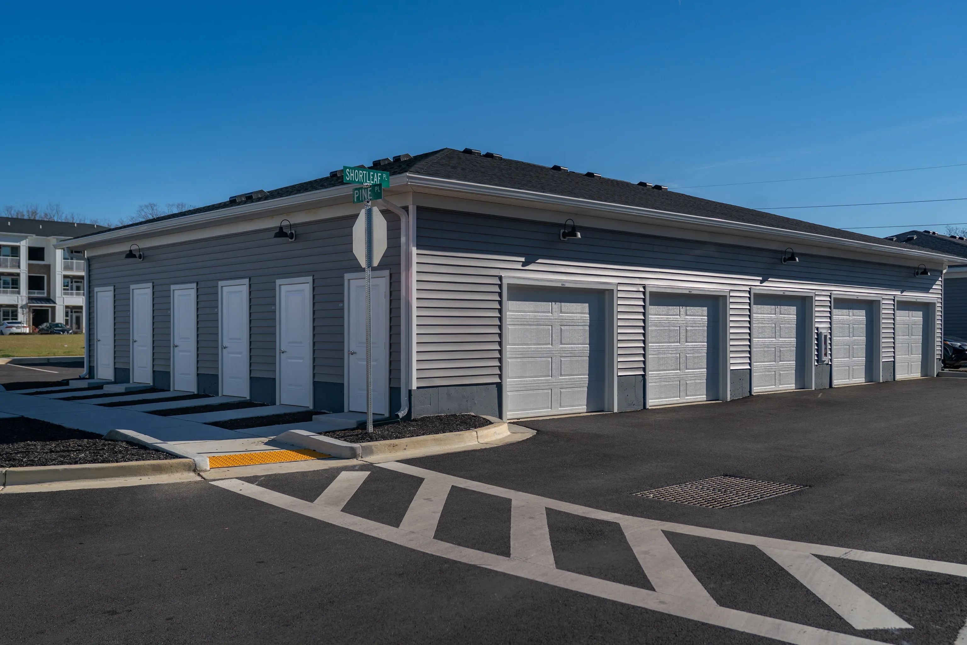 Garage doors and entrances on a building exterior.