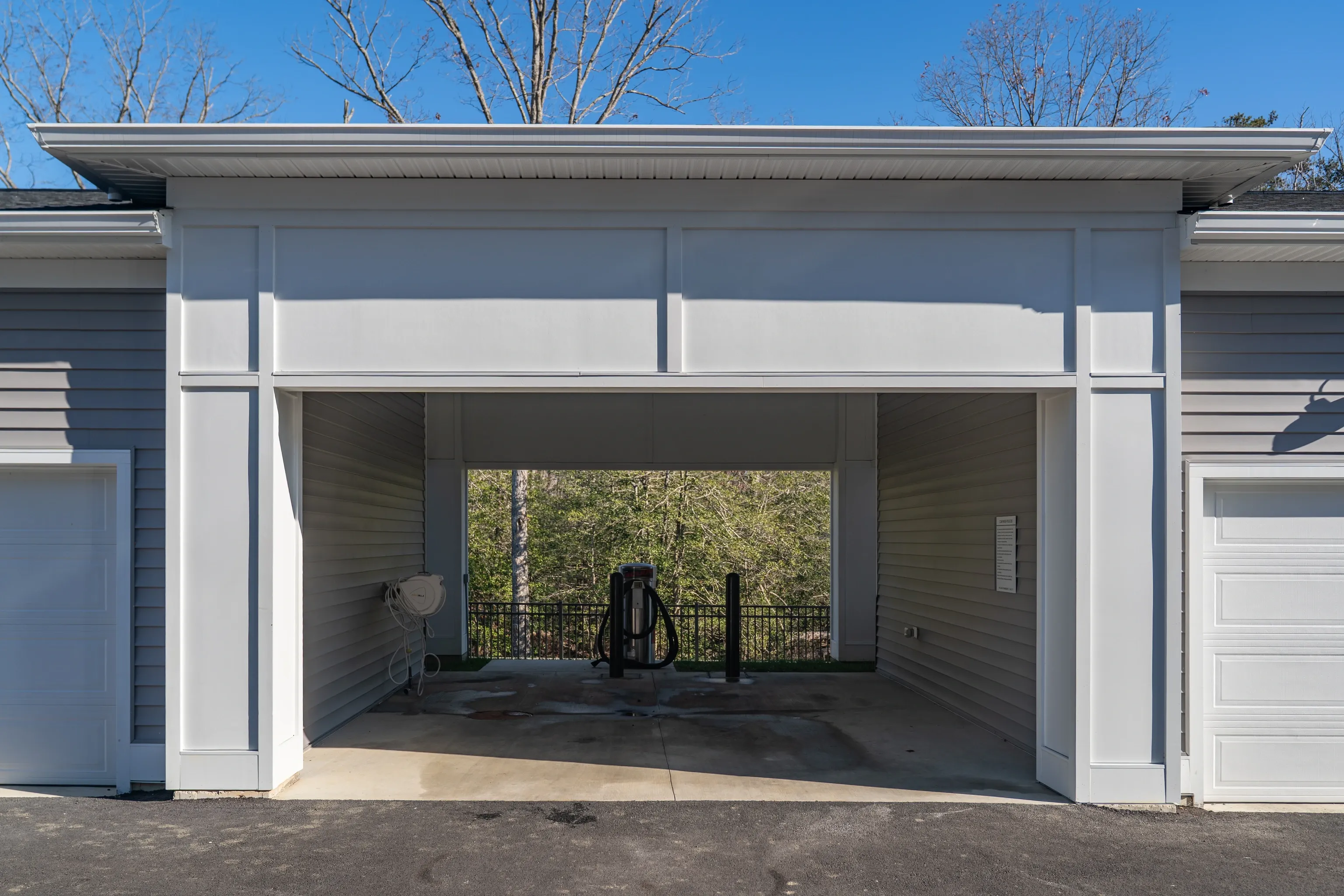 Covered parking area with car vacuum and hose