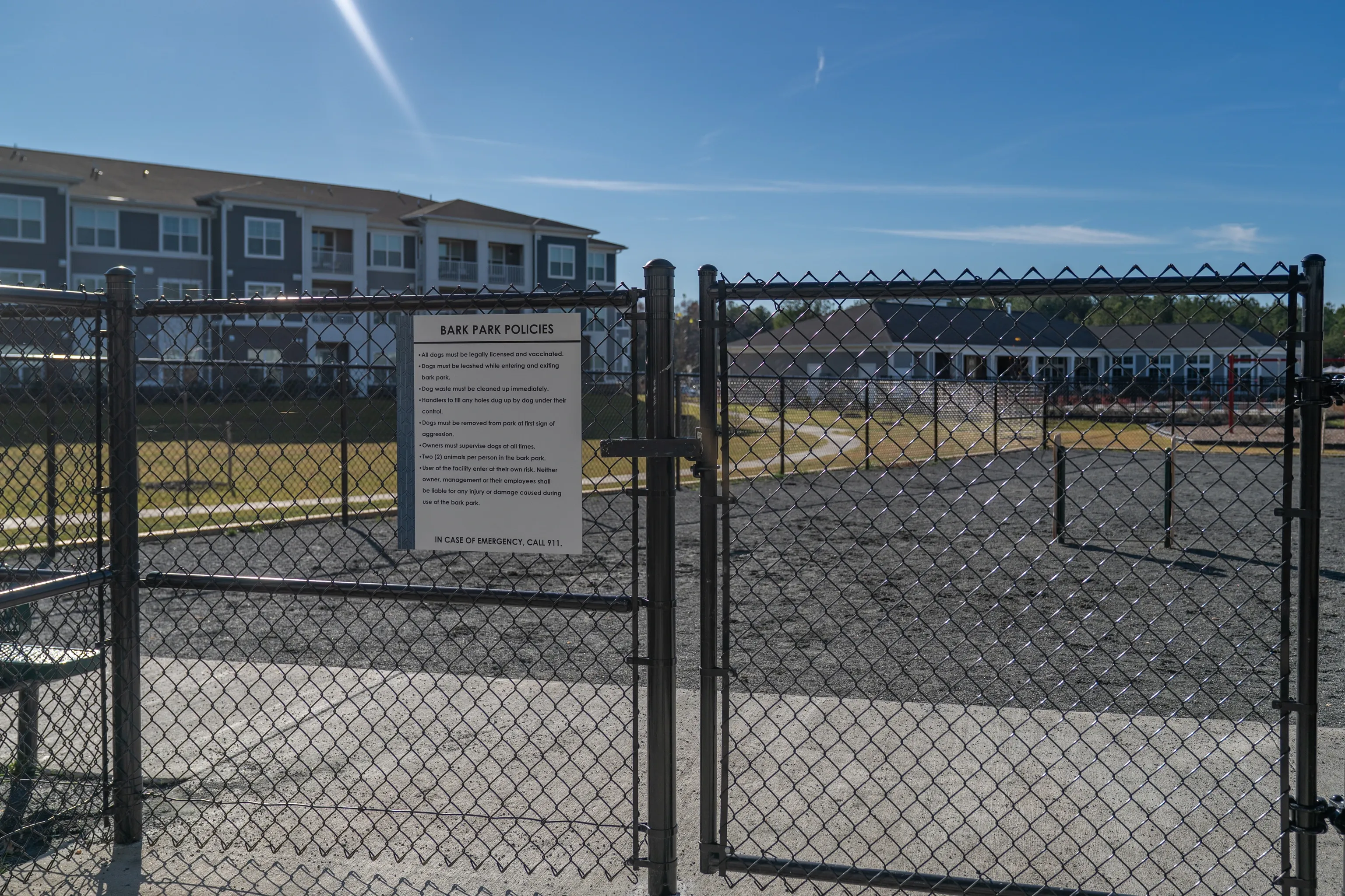 Dog park entrance with policies sign