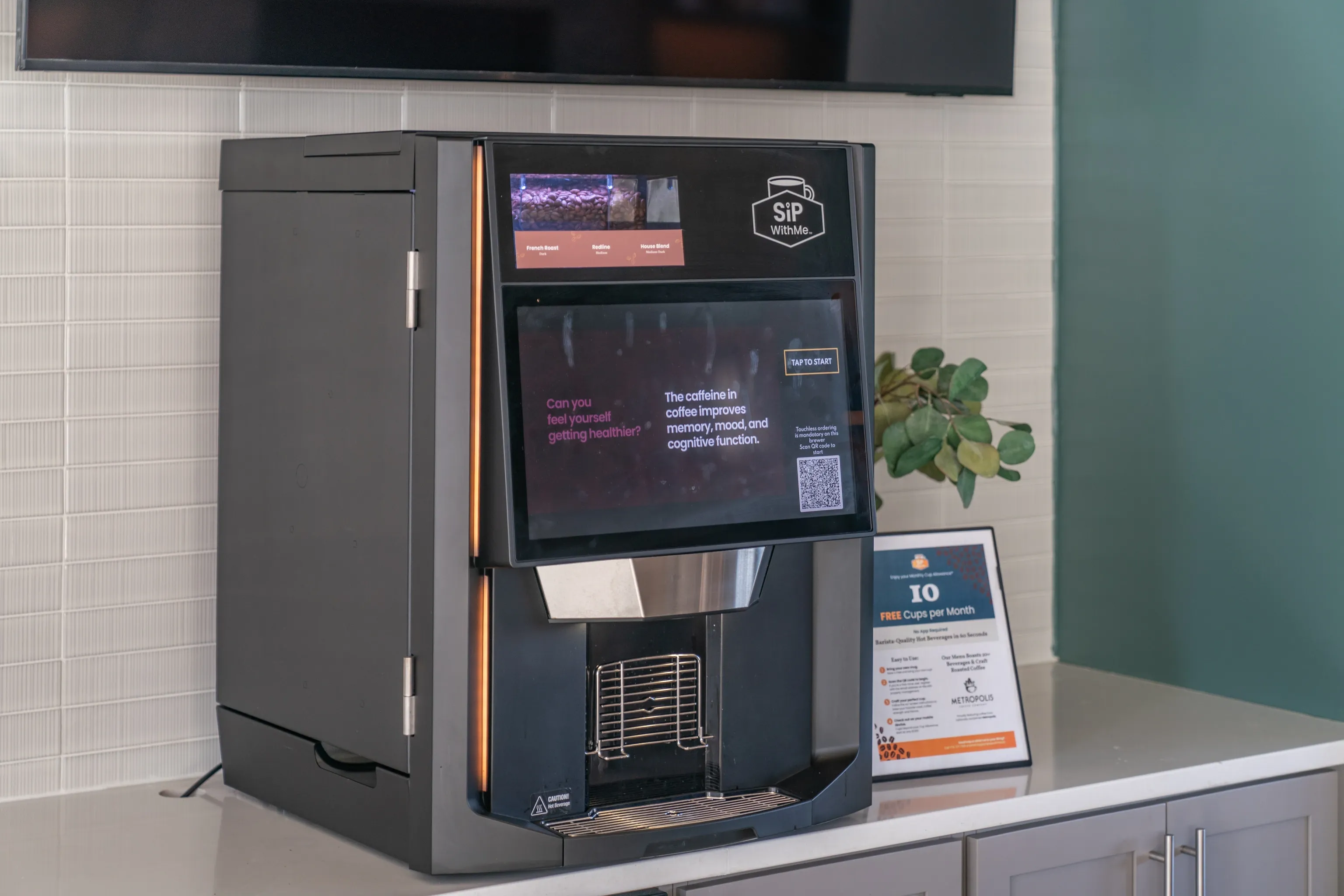 Modern coffee machine with a digital display in a multifamily property common area.