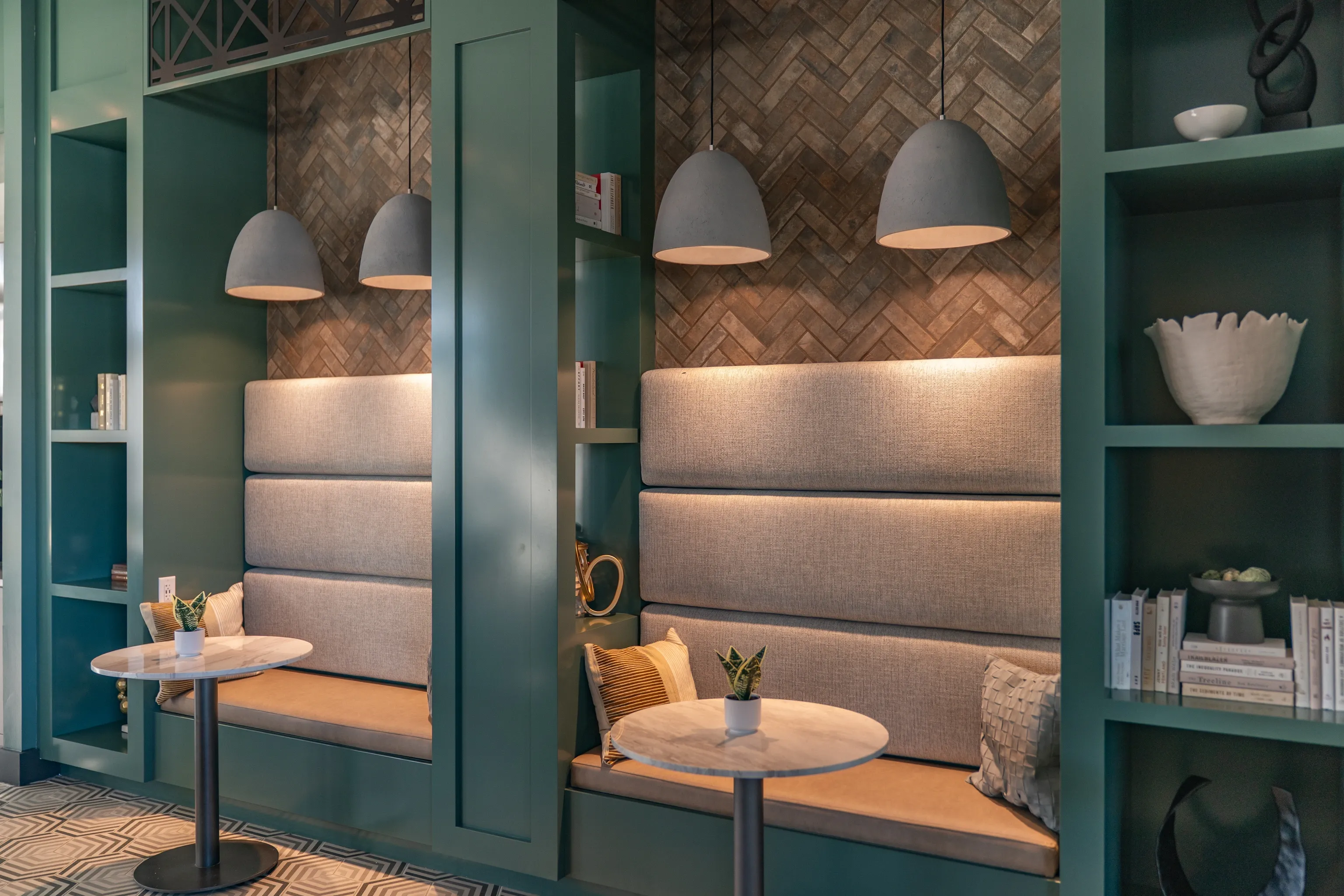 Cozy seating nooks with built-in benches and marble-top tables.