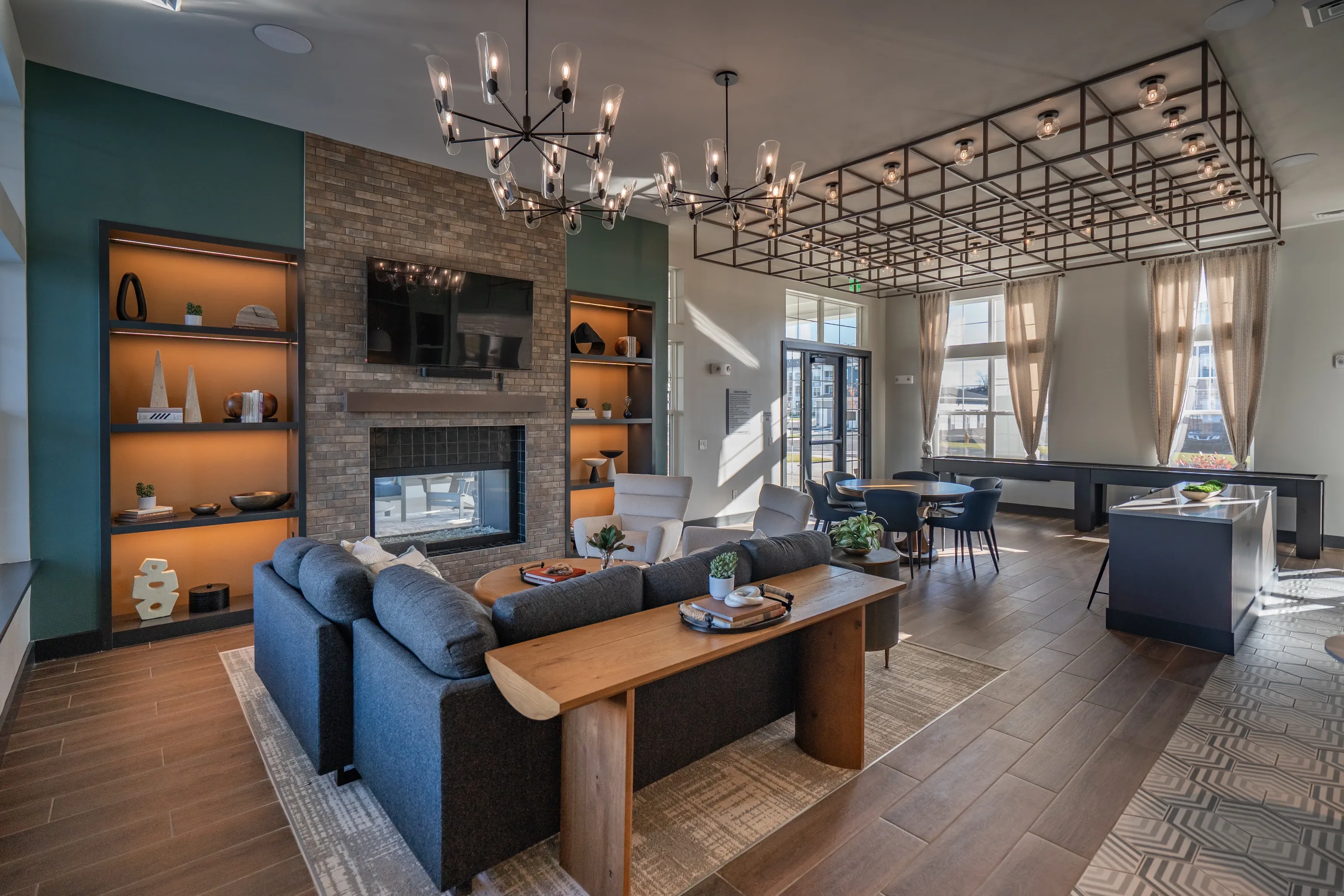 Modern lounge area with fireplace, seating, and pool table.
